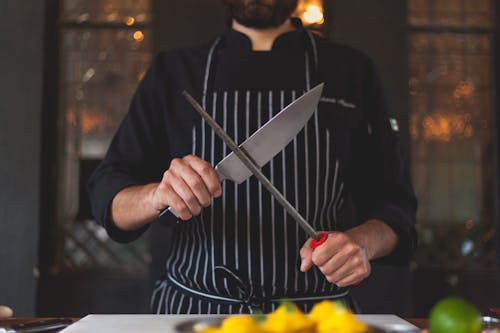 Free Man Sharpening a Knife Stock Photo